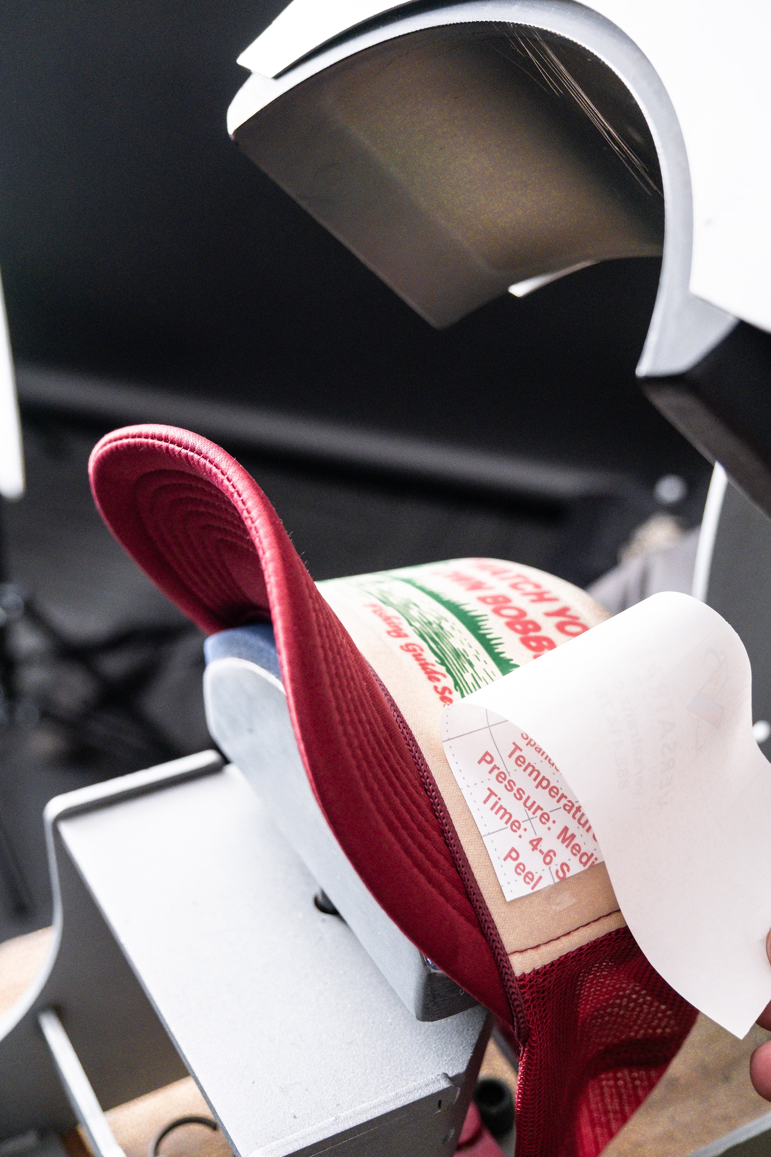 Signup page backgroup, peeling a transfer off of a hat